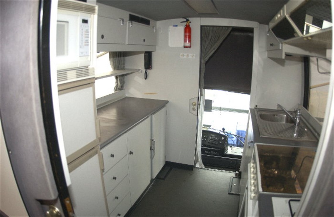 Galley kitchen looking forward to Drivers area with folding bunk above.