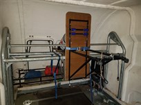 Tyre rack with table in up position.  Compressed cylinder mount on bottom left of pic.  Front hatch, nose/wing mount on underside of table, fuel drum storage behind table