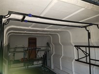 Rear rack with spare wing mount on ceiling and flat screen TV mount on the right side